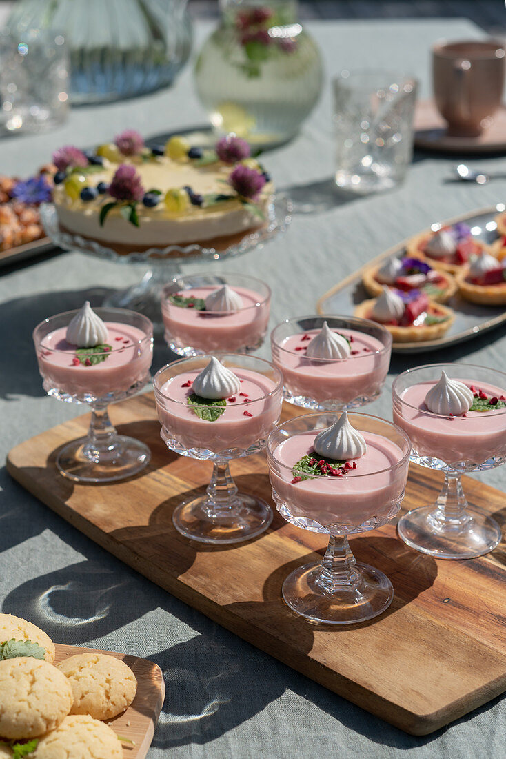 Dessert glasses on a table laid on a terrace