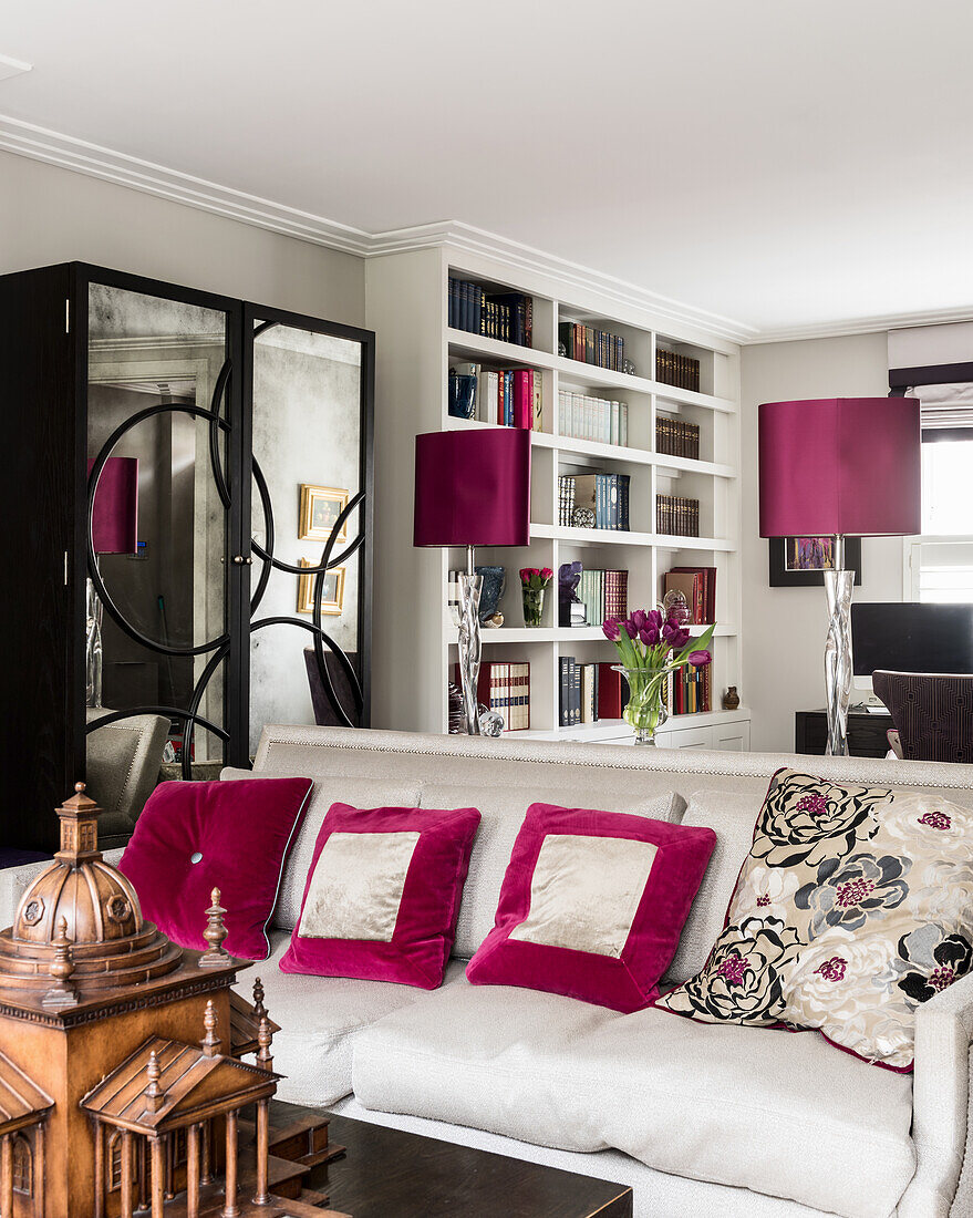 Fuschia sating shades with mirrored cabinet and bookcase