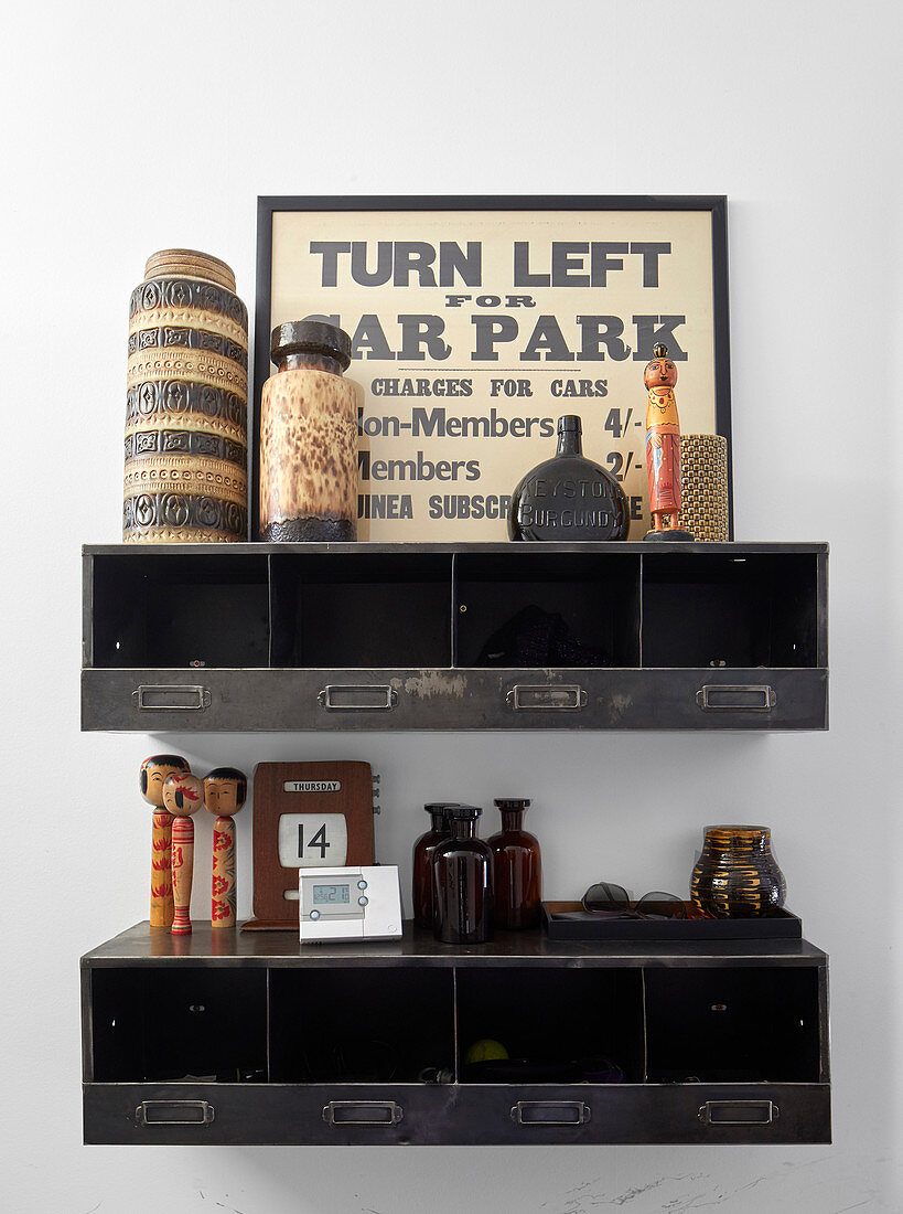 Vases, sign and knick-knacks on shelves made from old metal cases
