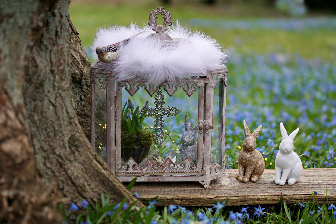 Easter bunny and grape hyacinths in the glass shrine and Easter bunnies on wooden board