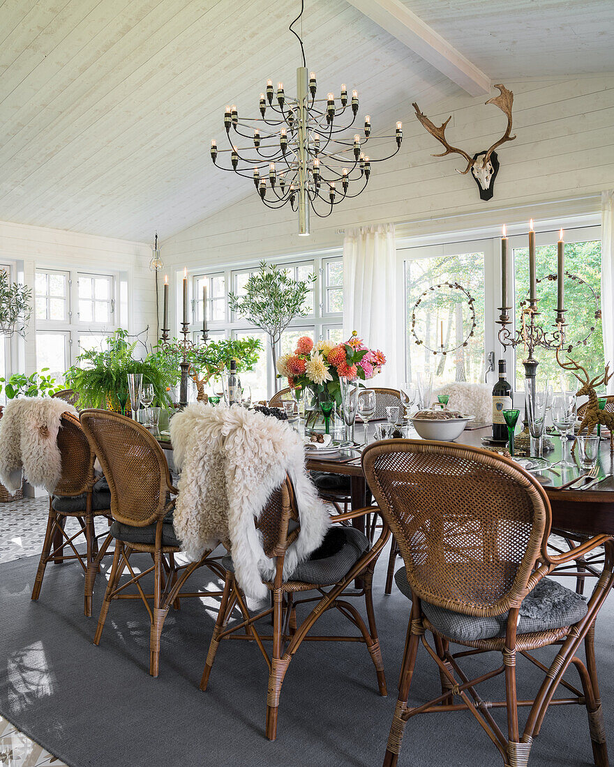 Covered dining table with wicker chairs in the conservatory