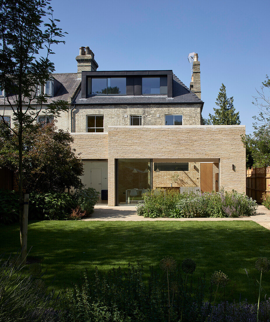 A view from a garden of a Victorian semi-detached house with an extension