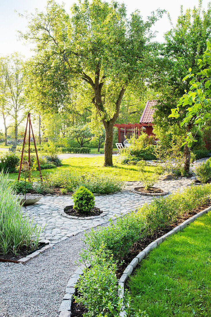 Spring garden with paving stones and gravel path