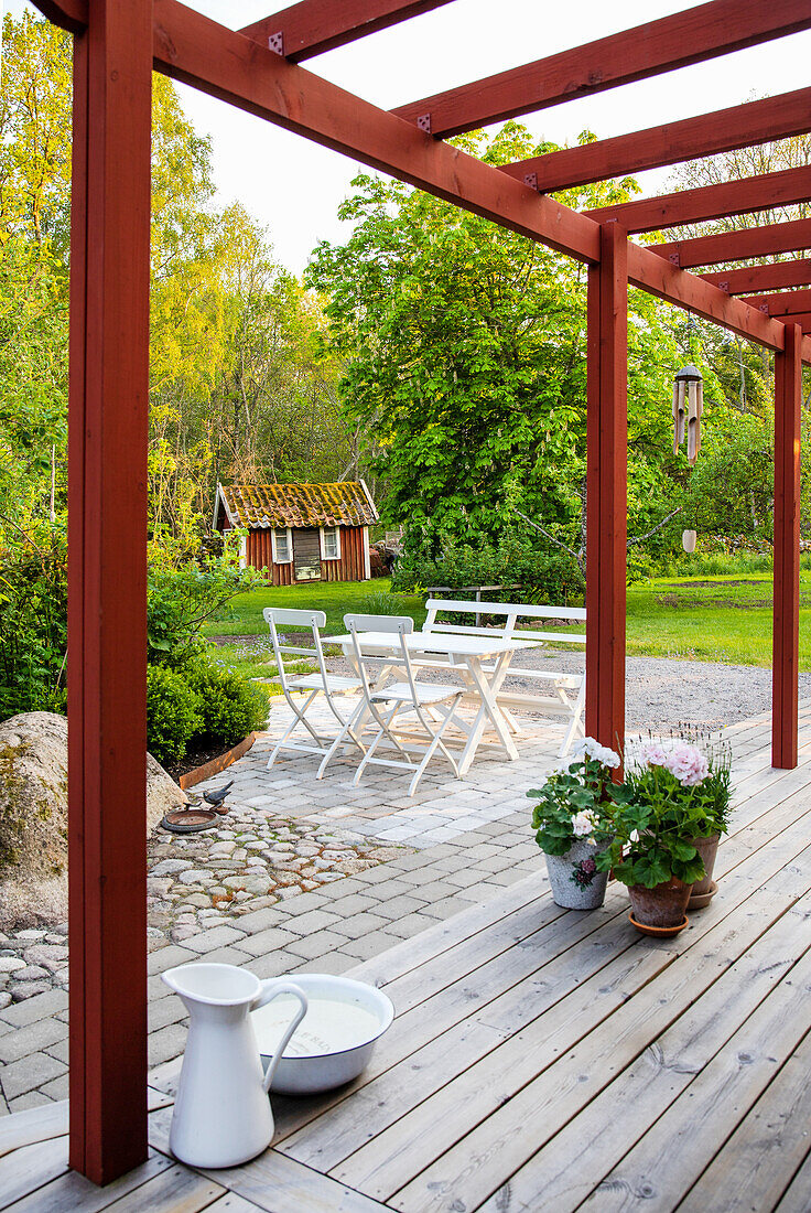 Red painted pergola and seating area