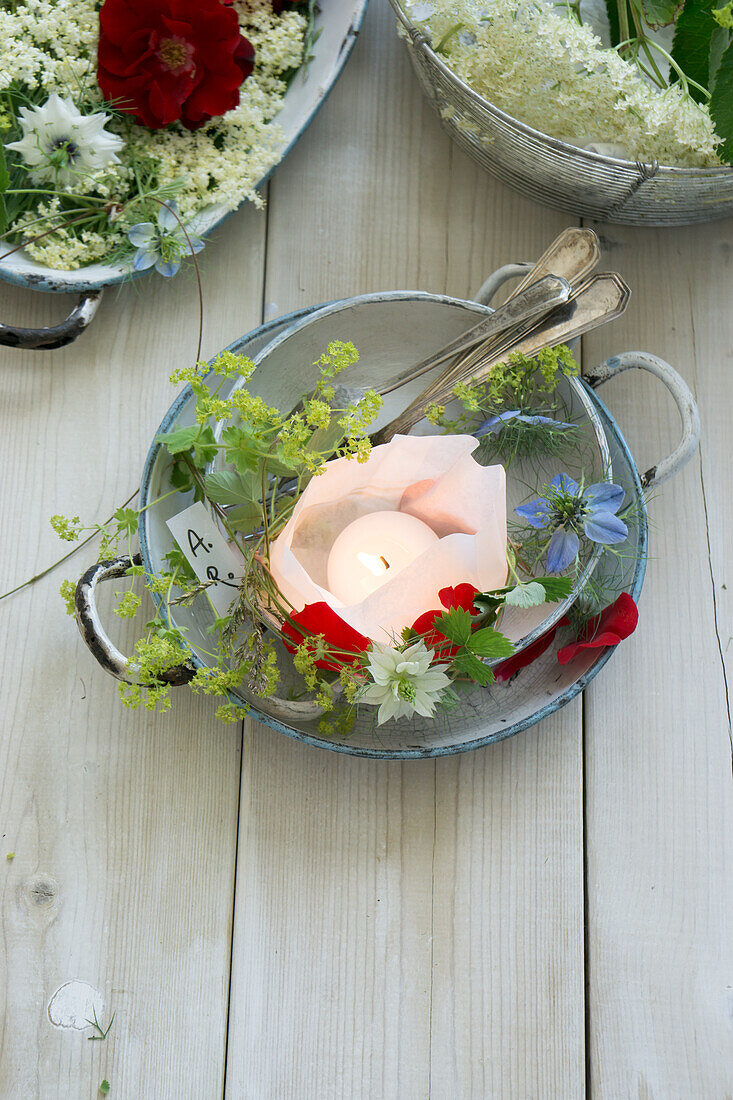 Candle lantern and spring blossoms in a bowl