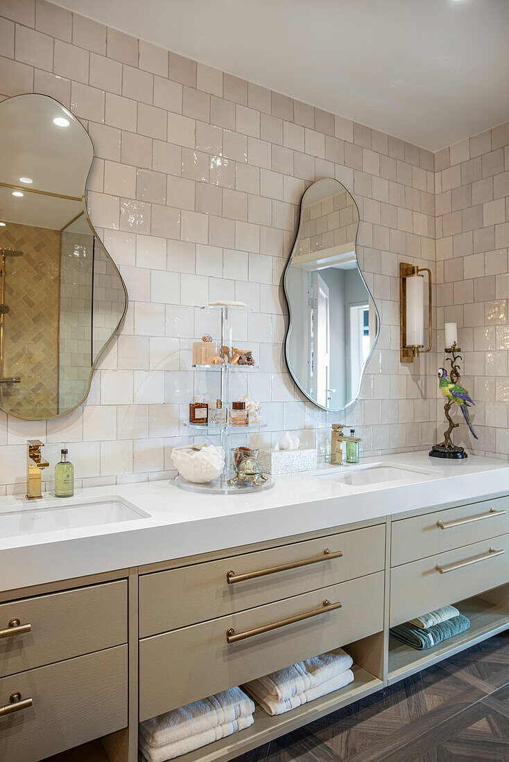 Elegant bathroom with long vanity and two organically shaped wall mirrors