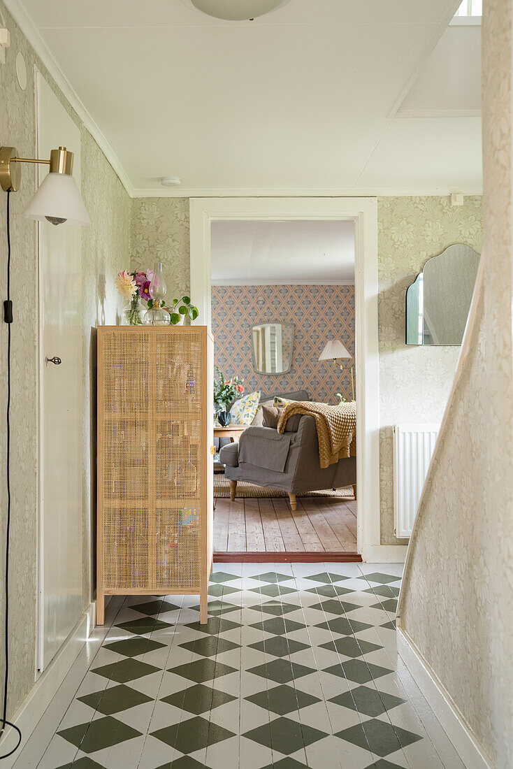Hallway with checkered painted wooden floor and view into the living room