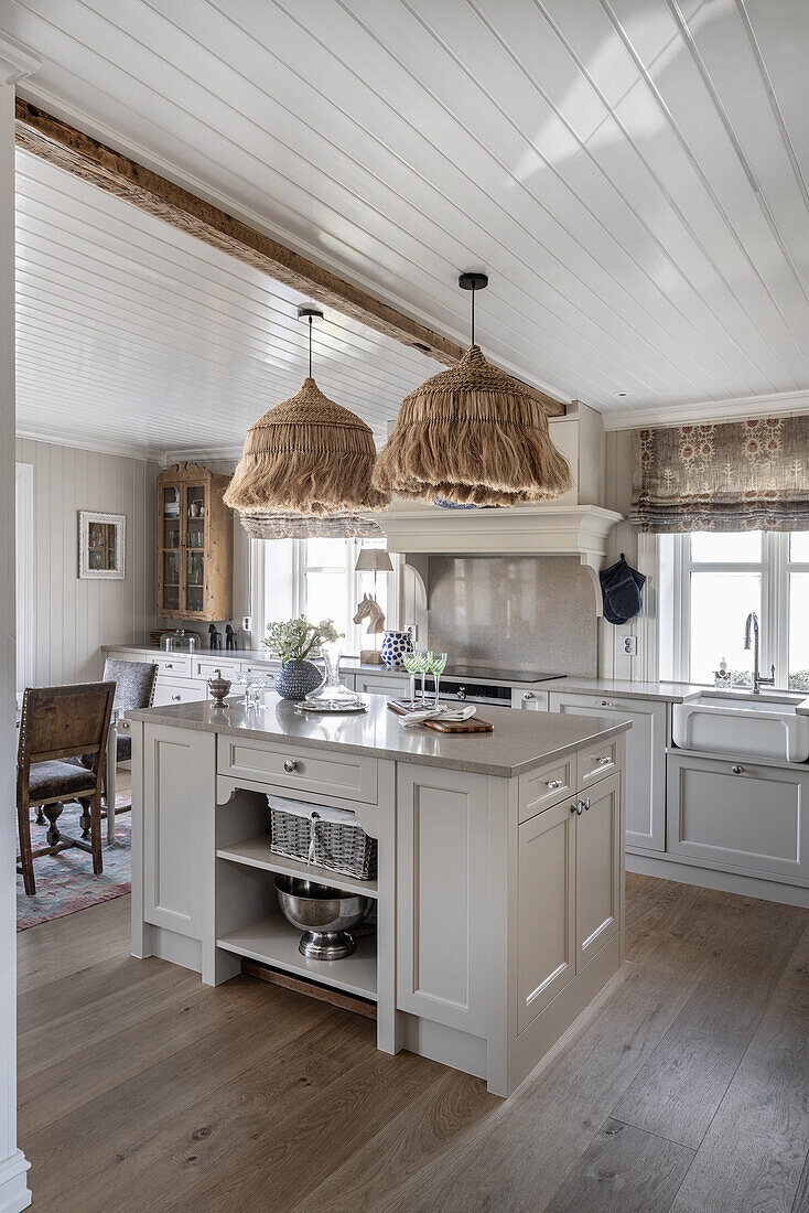 Center island and boho lamps in bright kitchen