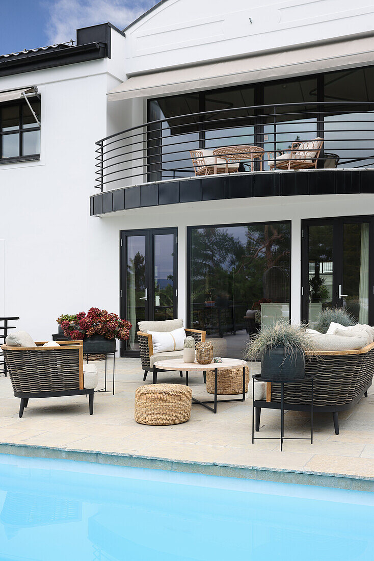 Elegant outdoor furniture on terrace with pool