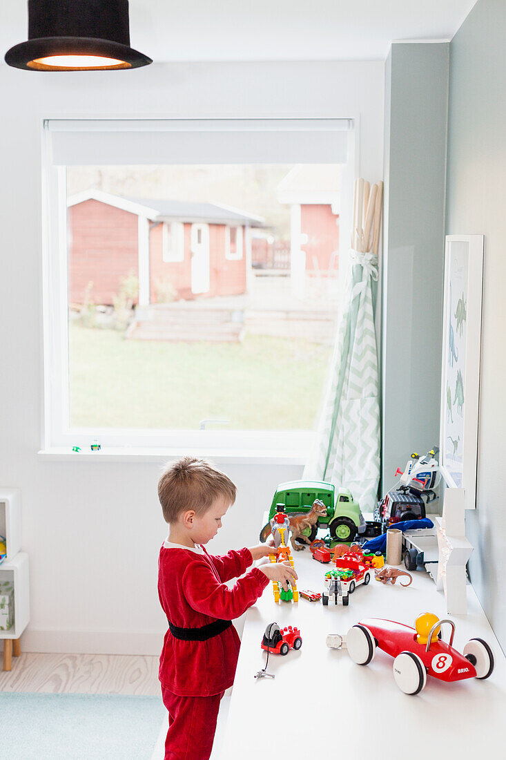 Boy playing with toys in his room