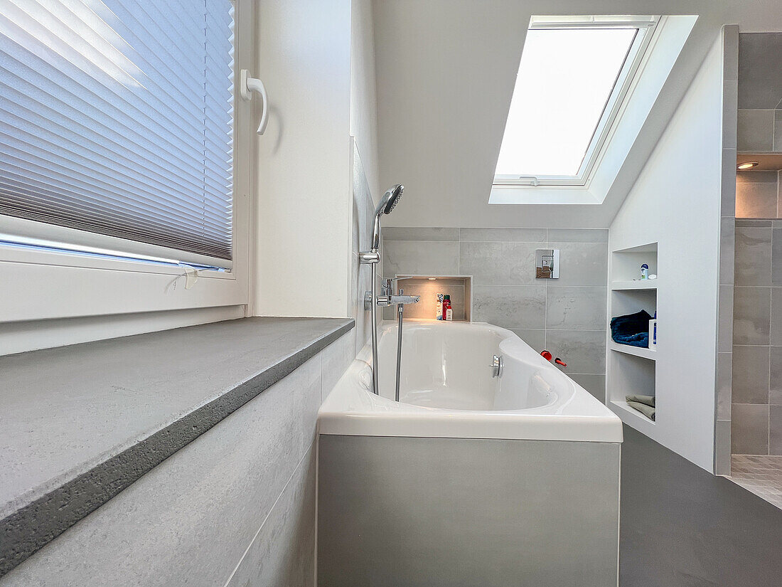 Bathroom with skylight and built-in ceramic bathtub