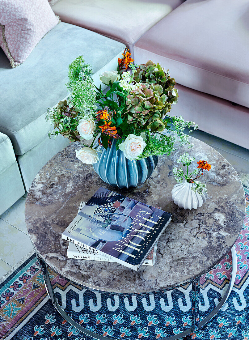 Circular coffe table with ornate vase and flowers