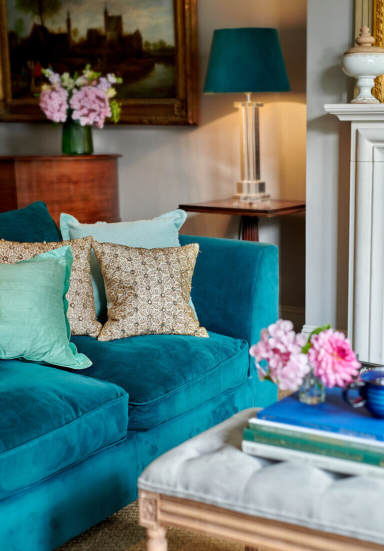 Turquoise blue upholstered sofa with throw pillows in the living room