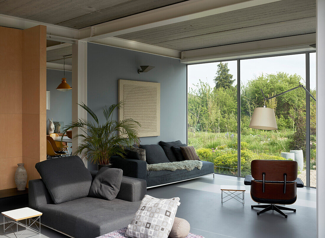 Living room with various seating and a garden view