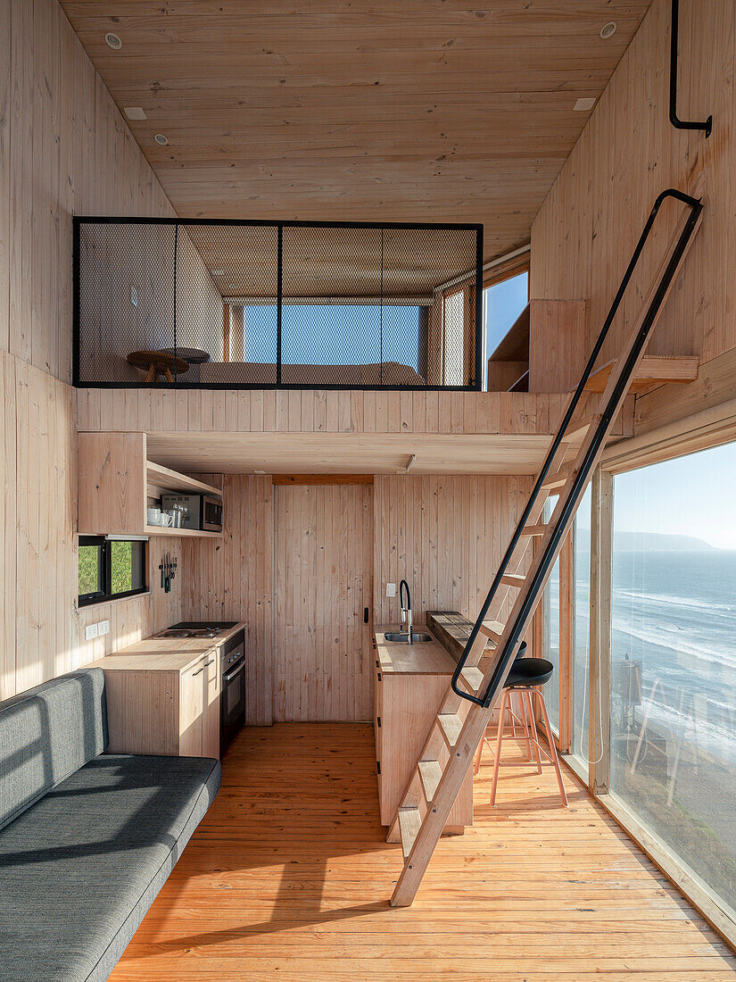 Sleeping loft area above the kitchen in the wooden house