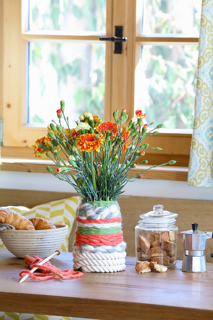 Carnations in woven flower vase