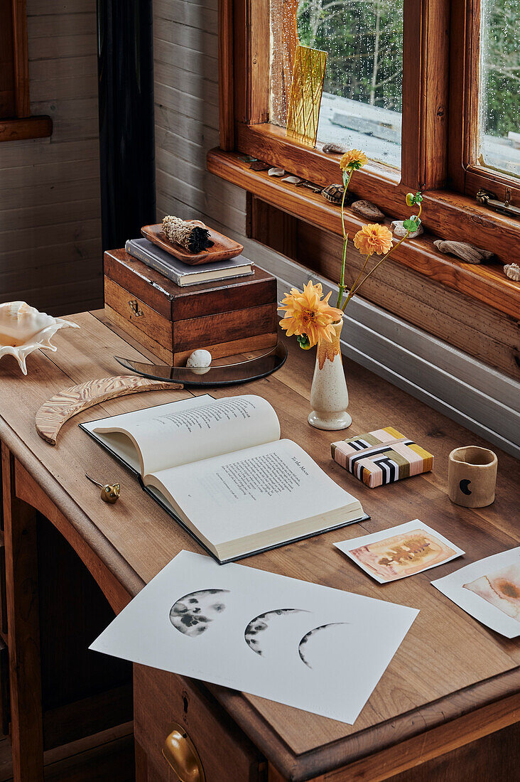 Desk with book, print, ceramic moon and wooden box