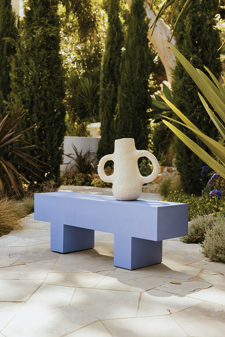 Blue bench with paper mâché vessel