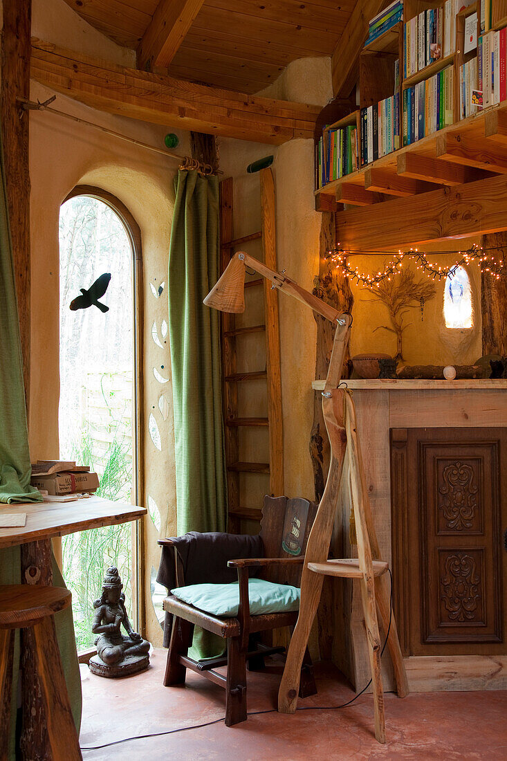Reading nook in front of arched window in rustic ambience