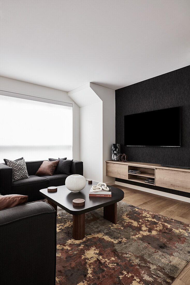 Modern living room with black sofas and black column coffee table