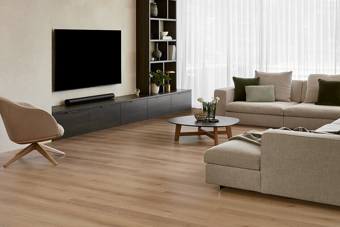 Modern living room in neutral tones with built-in cabinets and cream modular sofa