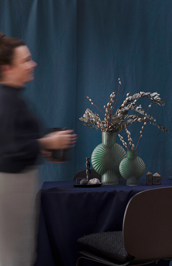Dark green shell vases with pussy willows and eucalyptus branches