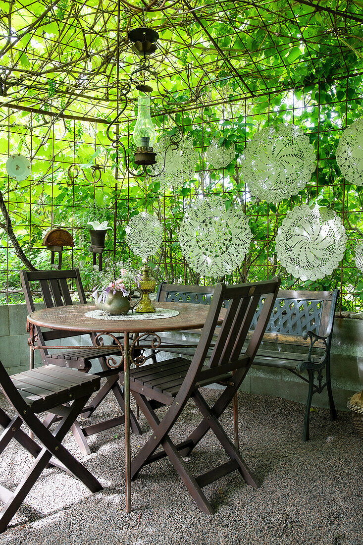 Green seating area with delicate lace hanging decorations
