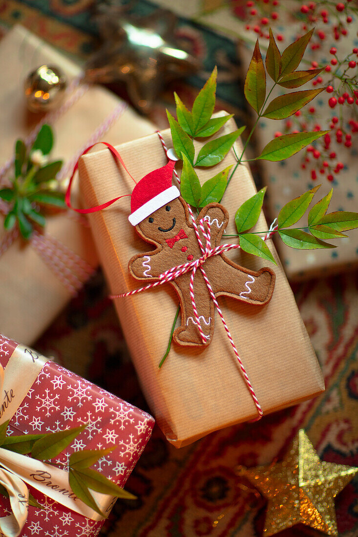 Christmas-wrapped gift with gingerbread man and red and white string