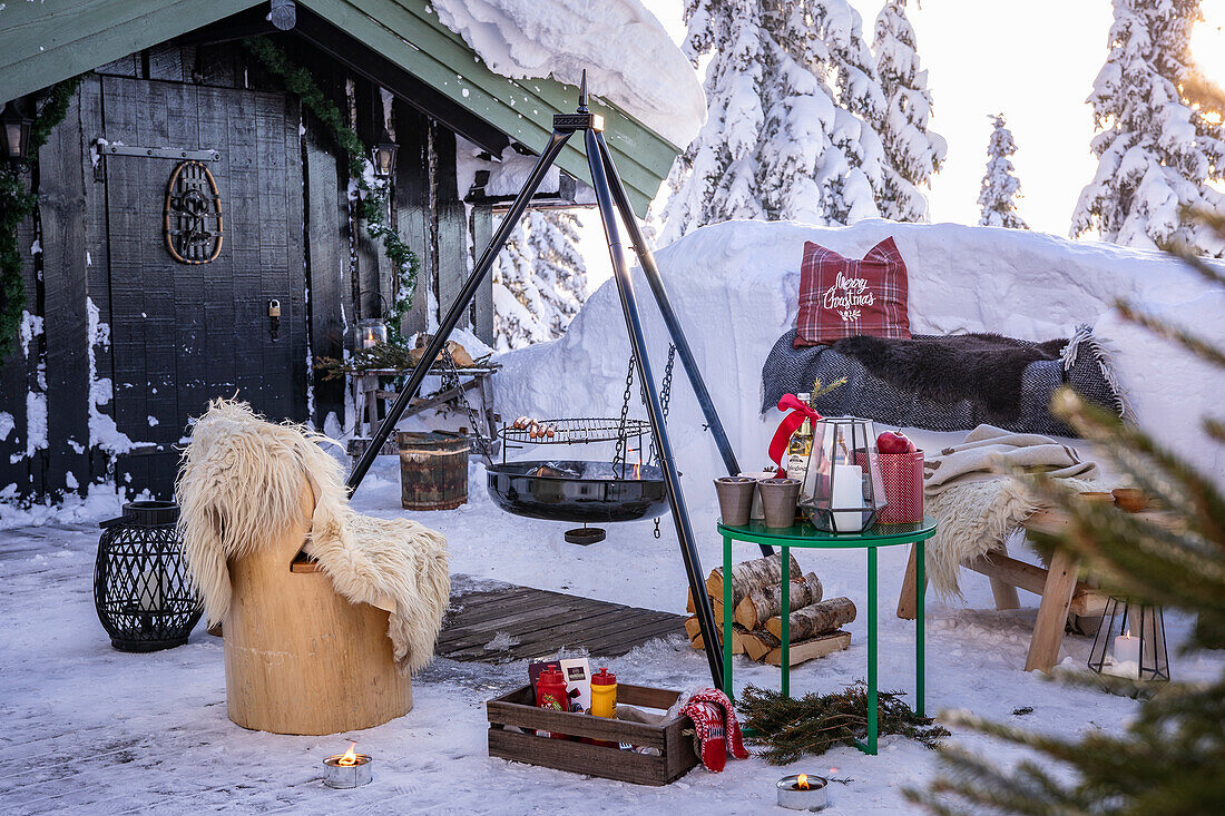 Winterlicher Außenbereich mit Feuerstelle und Weihnachtsdekoration