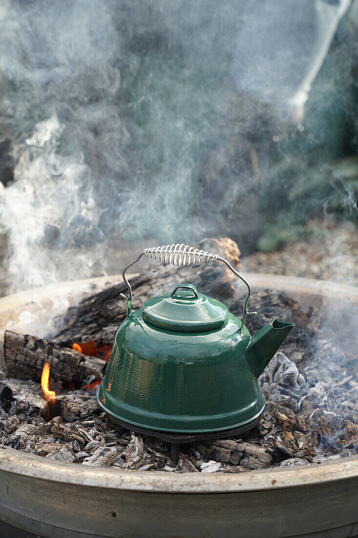 Green kettle on an open fire