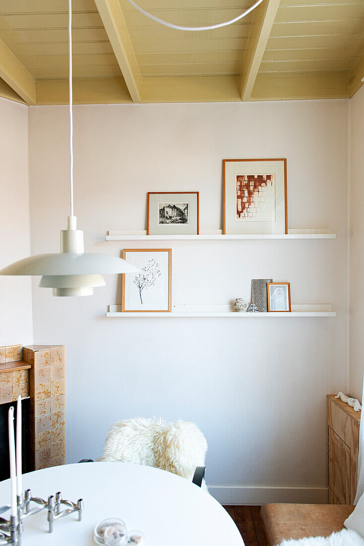 Dining area with white table, pendant light and picture rails