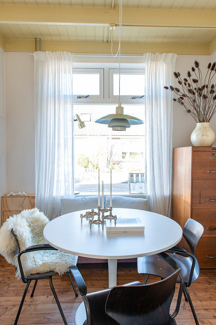 Dining area with round table and pendant light