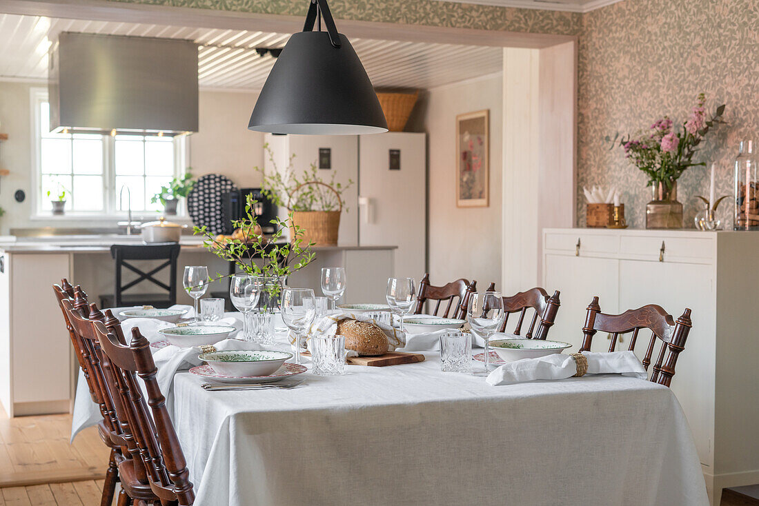 Country-style dining table with twig decorations and pendant light