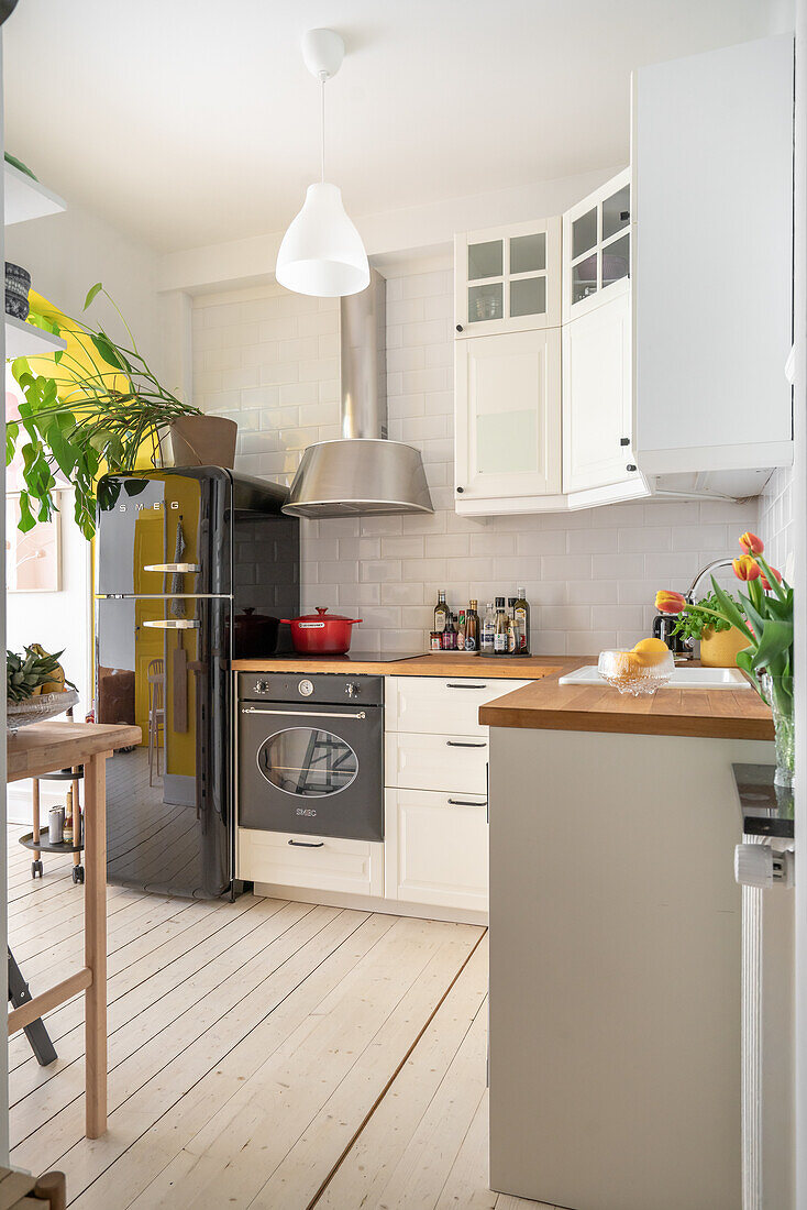 Bright kitchen with white cupboards and retro fridge