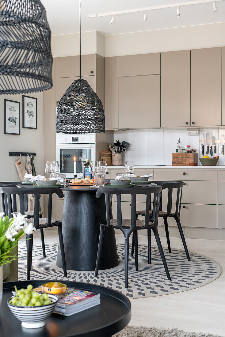 Modern kitchen with dining table and black chairs