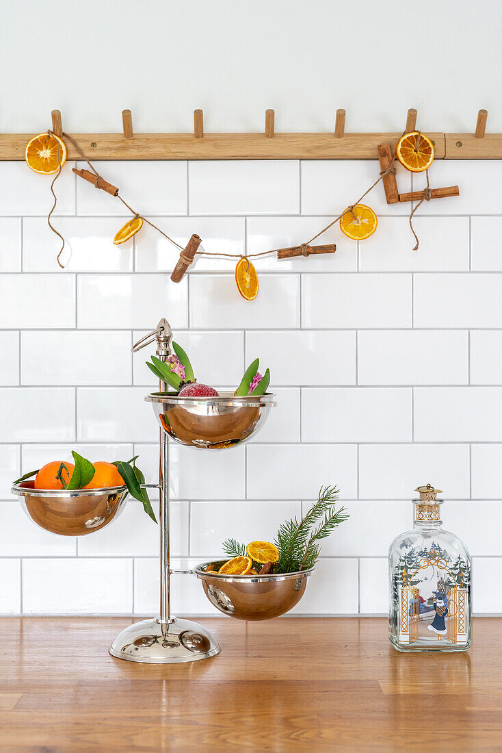 Decoration made from dried orange slices and cinnamon sticks on a wooden hook rail