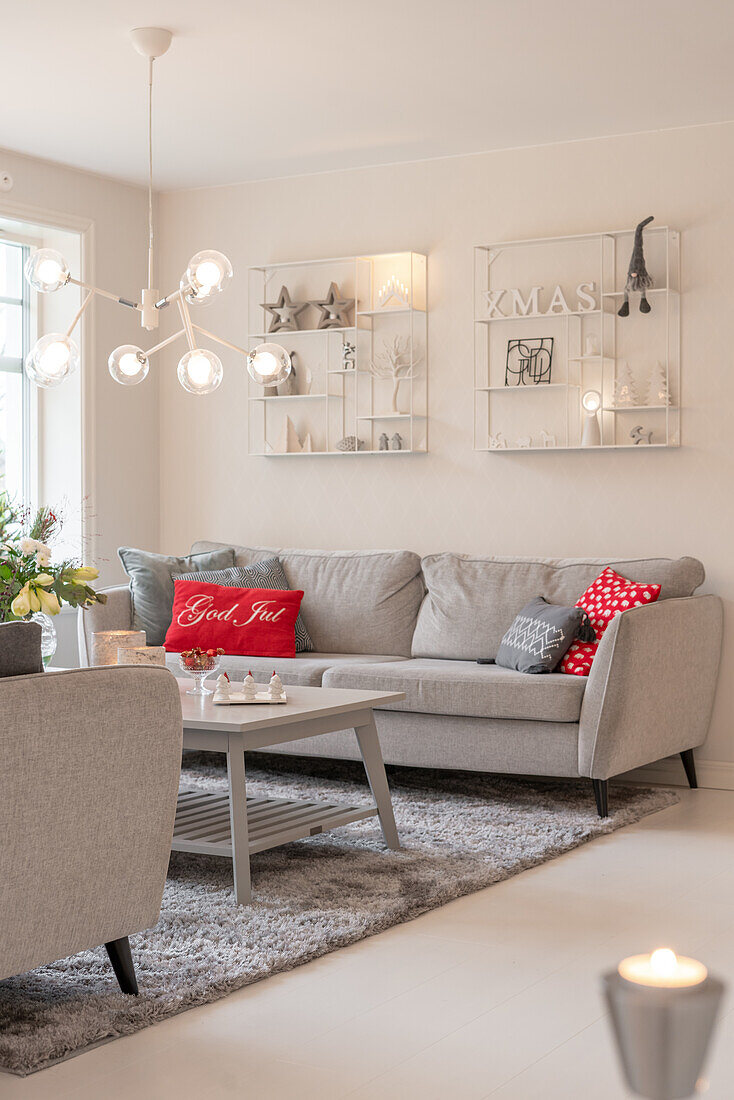 Living room decorated for Christmas with a modern couch and decorative cushions