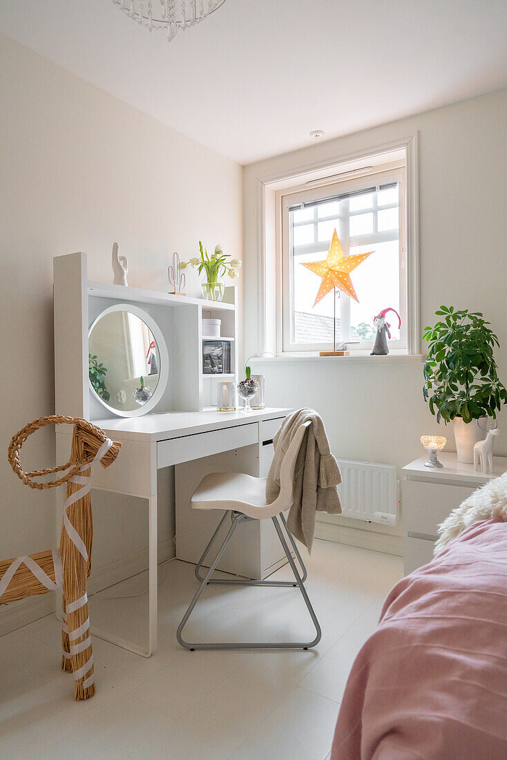 Dressing table with mirror and star decorations by the window in the bedroom