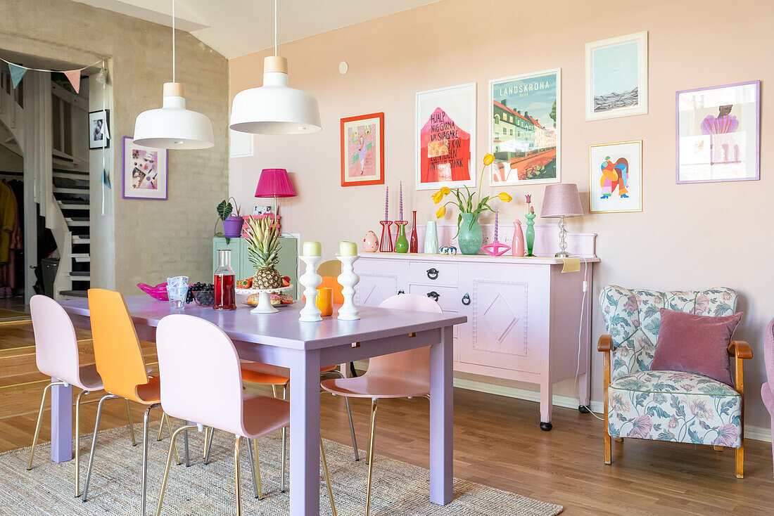 Colourful dining area with murals and furniture in pastel shades