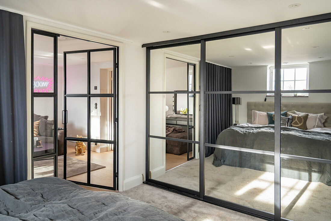 Bedroom with mirrored wardrobe and glass door