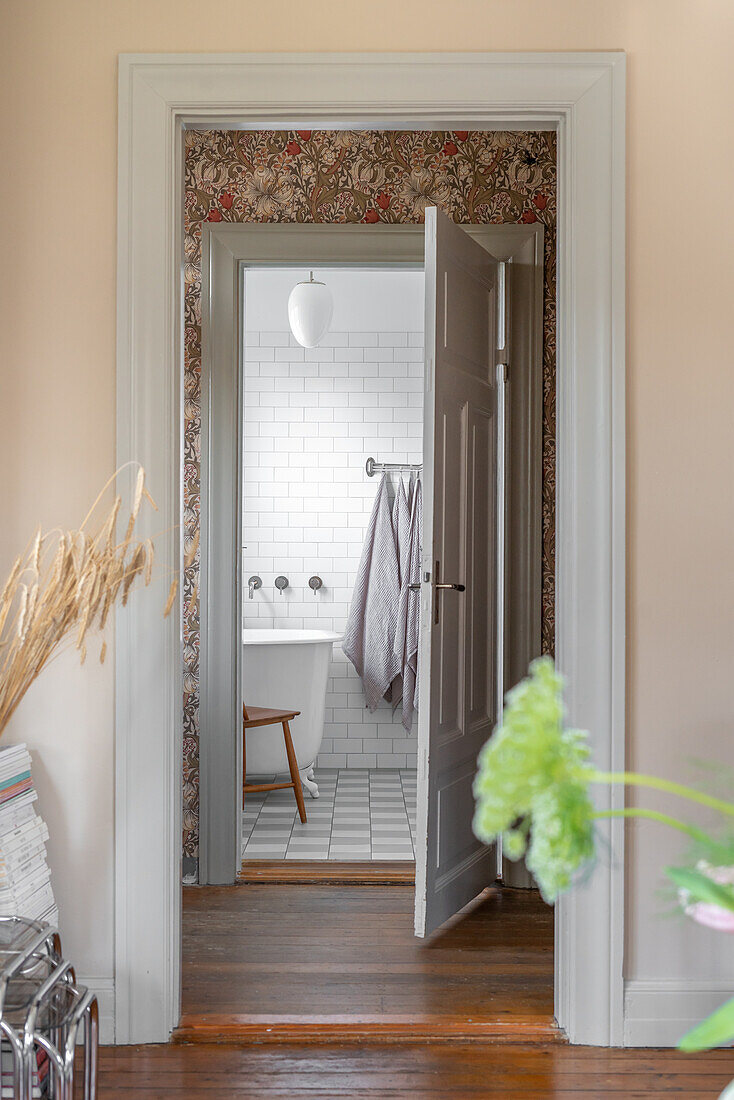 View of a bathroom with white wall tiles and bathtub