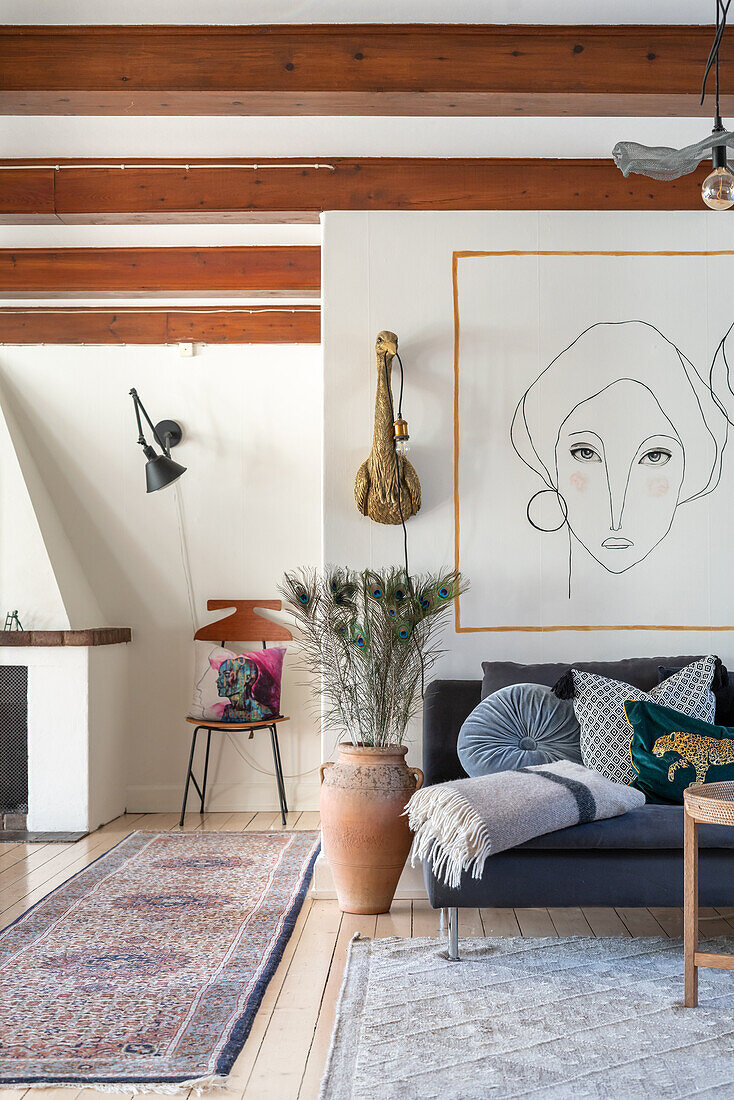 Living room with artwork, ceiling beams and decorative elements