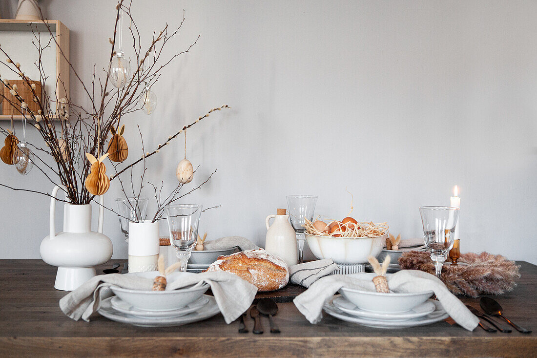 Easter table decorated with bread, eggs and candle