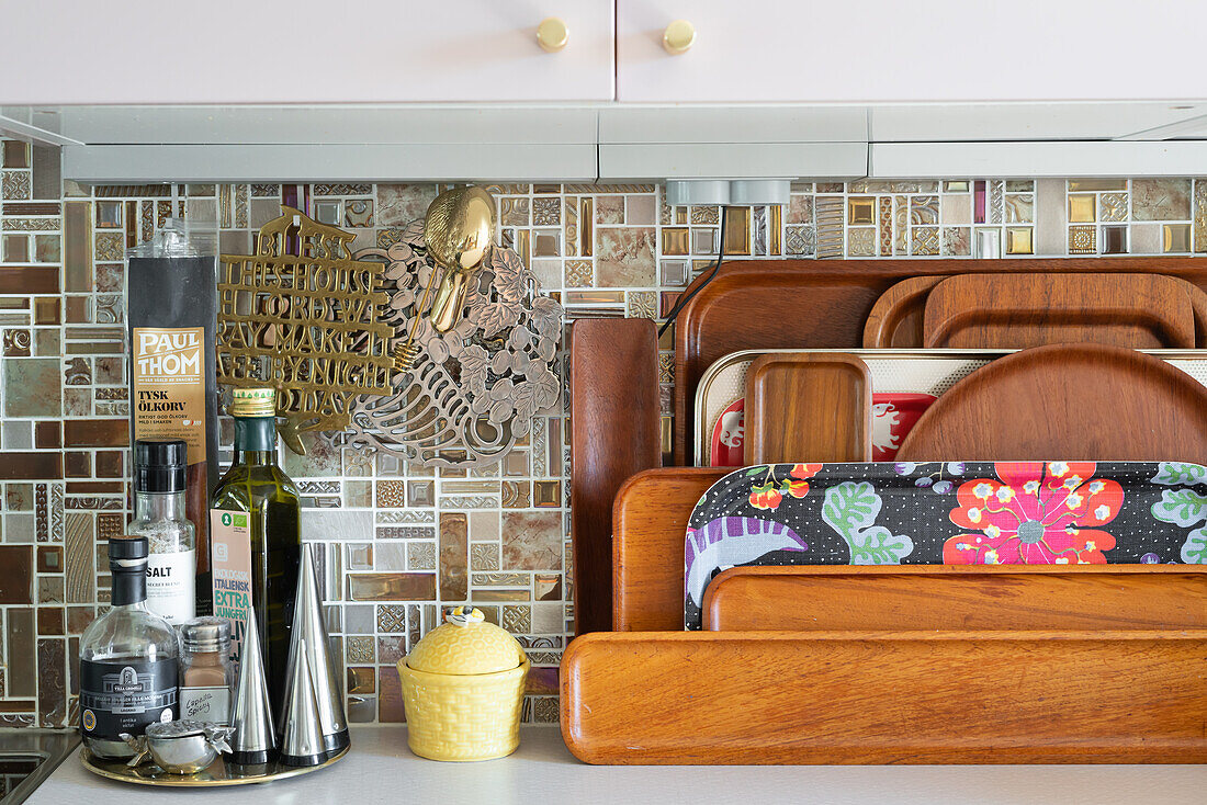 Various trays in a kitchen with mosaic tiles