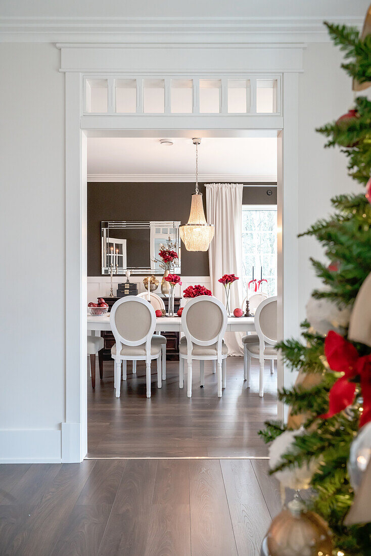 Elegant dining room with Christmas decorations and red accents