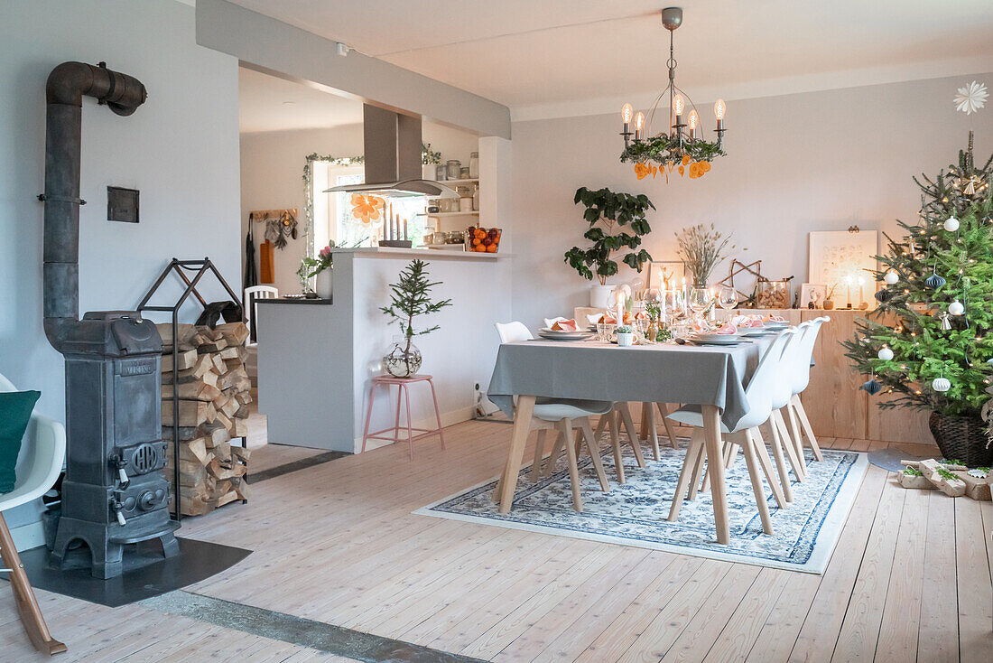 Festive table with wood-burning stove and Christmas tree