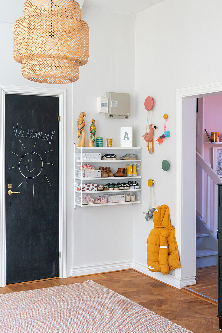 Hallway with coat hooks, shelf and door with chalkboard paint