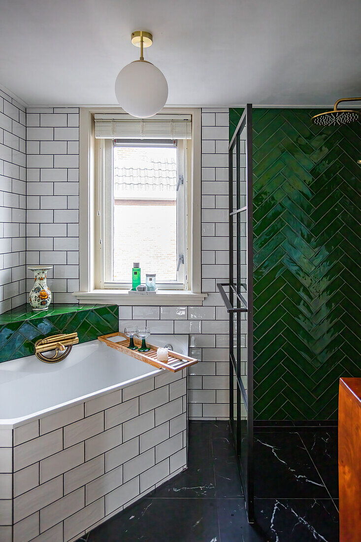 Bathroom with green and white metro tiles, bath and shower