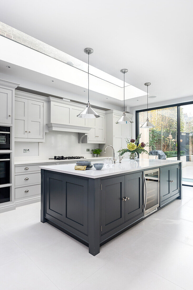 Airy kitchen with skylight and floor-to-ceiling glass doors to the terrace