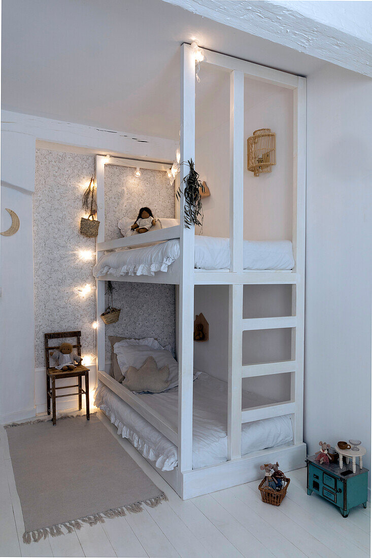 Bunk bed in white with fairy lights and vintage decorative elements